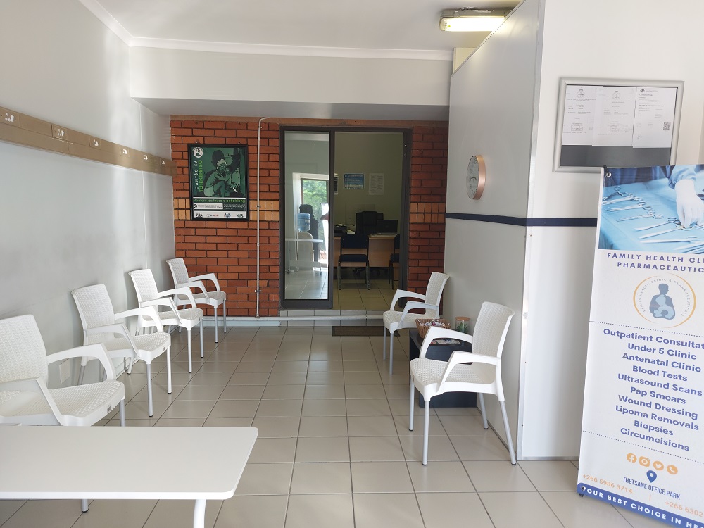 The waiting area at Family Health Clinic, with seating and a service information banner